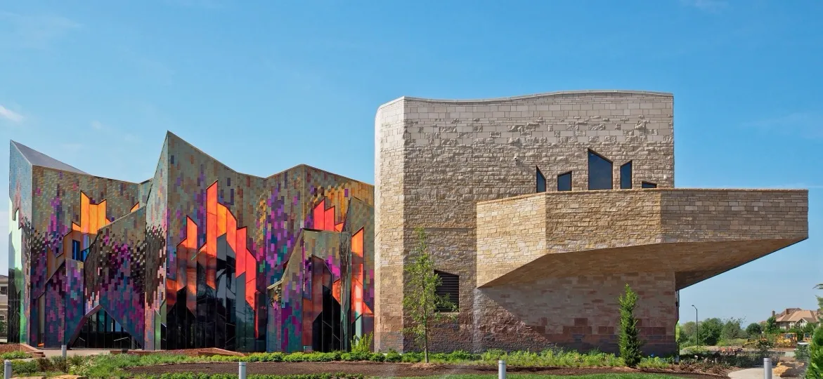 The Museum at Prairiefire, Overland Park, Kansas: the building's colorful patterned front beside a limestone wing, seen across the lawn